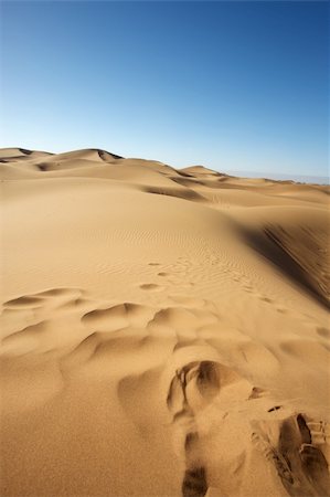 Sahara desert close to Merzouga in Morocco with blue sky and clouds Stock Photo - Budget Royalty-Free & Subscription, Code: 400-04316196