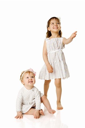 sister hugs baby - Two little Sisters looking up with interest isolated on white Stock Photo - Budget Royalty-Free & Subscription, Code: 400-04316780