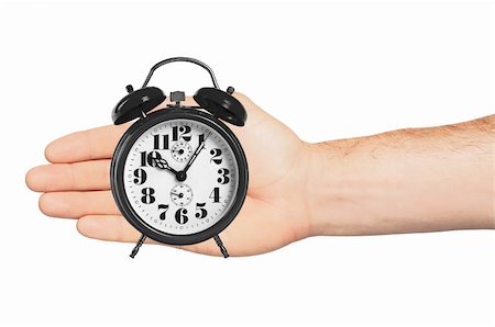 alarm clock in hand isolated on white background Stock Photo - Budget Royalty-Free & Subscription, Code: 400-04317140