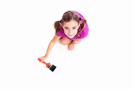 Top view of a happy girl sitting on floor holding a paint-brush Stock Photo - Budget Royalty-Free & Subscription, Code: 400-04317587