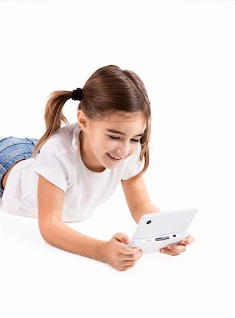 Little girl lying on floor playing a video-game Stock Photo - Budget Royalty-Free & Subscription, Code: 400-04317589