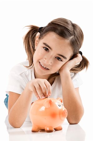 Little girl lying on floor and inserting a one euro coin on the piggy-bank Stock Photo - Budget Royalty-Free & Subscription, Code: 400-04317595