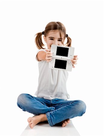 Little girl sitting on floor playing a video-game Stock Photo - Budget Royalty-Free & Subscription, Code: 400-04317590