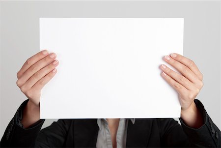 simsearch:400-05718227,k - Woman showing a blank paper sheet in front of her head Stock Photo - Budget Royalty-Free & Subscription, Code: 400-04317621