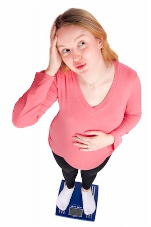 pregnant high angle - Worried pregnant woman standing on scales isolated on white Photographie de stock - Aubaine LD & Abonnement, Code: 400-04318210