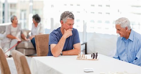 Seniors playing chess at home Stock Photo - Budget Royalty-Free & Subscription, Code: 400-04318648