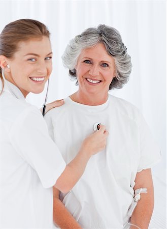 family visiting patient hospital bed - Retired patient with her nurse looking at the camera Stock Photo - Budget Royalty-Free & Subscription, Code: 400-04318681