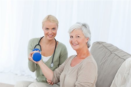 Beautiful nurse helping her patient to do exercises Stock Photo - Budget Royalty-Free & Subscription, Code: 400-04318717