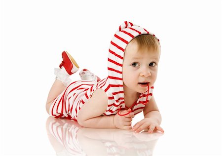 Toddler girl lying on floor isolated on white Stockbilder - Microstock & Abonnement, Bildnummer: 400-04318989