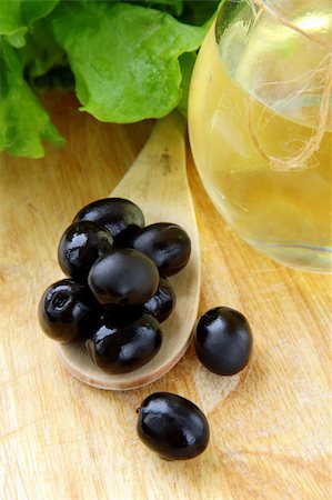 eating olive - black olives and a bottle of olive oil on a wooden table Stock Photo - Budget Royalty-Free & Subscription, Code: 400-04319220