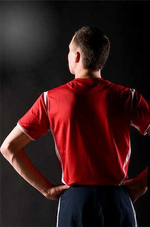 soccer shorts for boys - back of confident soccer player on dark background Stock Photo - Budget Royalty-Free & Subscription, Code: 400-04319259