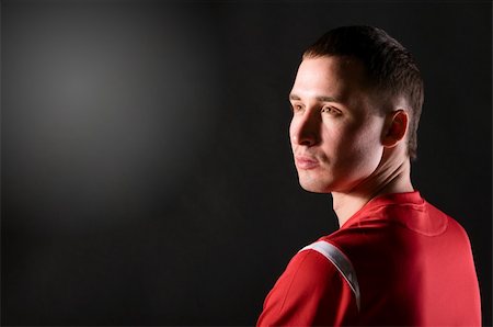 soccer player is looking sideways on dark background Stock Photo - Budget Royalty-Free & Subscription, Code: 400-04319260