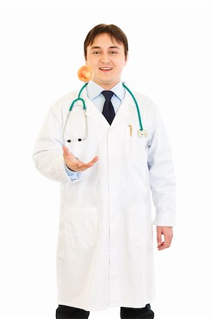 simsearch:400-04351236,k - Smiling medical doctor throwing up apple isolated on white Photographie de stock - Aubaine LD & Abonnement, Code: 400-04319728