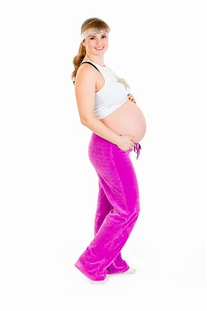 simsearch:400-04798379,k - Smiling beautiful pregnant woman in sportswear holding her tummy isolated on white Foto de stock - Super Valor sin royalties y Suscripción, Código: 400-04310604