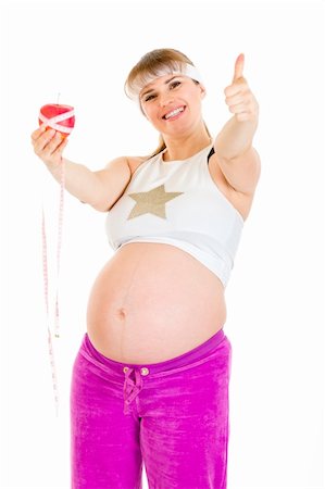 simsearch:400-04798379,k - Smiling pregnant woman with measure tape and apple showing thumbs up gesture Foto de stock - Super Valor sin royalties y Suscripción, Código: 400-04310617