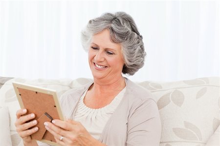 Woman looking at a photo at home Stock Photo - Budget Royalty-Free & Subscription, Code: 400-04311022