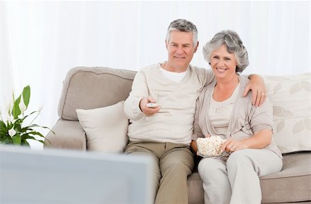 simsearch:400-04311095,k - Mature couple watching tv in their living room at home Stock Photo - Budget Royalty-Free & Subscription, Code: 400-04311056