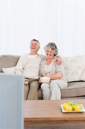 simsearch:400-04311095,k - Mature couple watching tv in their living room at home Stock Photo - Budget Royalty-Free & Subscription, Code: 400-04311057