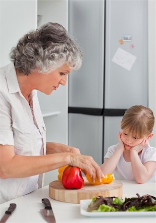 simsearch:400-04306457,k - Little girl looking at her grandmother who is cooking at home Stock Photo - Budget Royalty-Free & Subscription, Code: 400-04311164