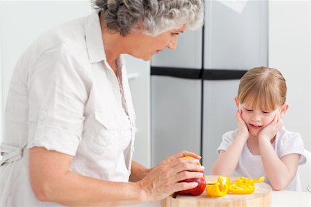 simsearch:400-04813285,k - Little girl looking at her grandmother who is cooking at home Stock Photo - Budget Royalty-Free & Subscription, Code: 400-04311165