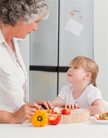 simsearch:400-04306517,k - Little girl looking at her grandmother who is cooking at home Stock Photo - Budget Royalty-Free & Subscription, Code: 400-04311168