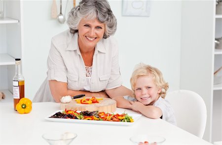 simsearch:400-04306457,k - Boy and his grandmother looking at the camera at home Stock Photo - Budget Royalty-Free & Subscription, Code: 400-04311188