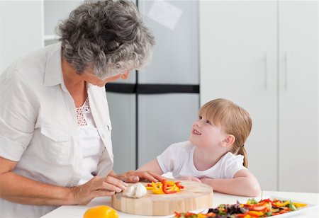 simsearch:400-04306517,k - Little girl looking at her grandmother who is cooking at home Stock Photo - Budget Royalty-Free & Subscription, Code: 400-04311181