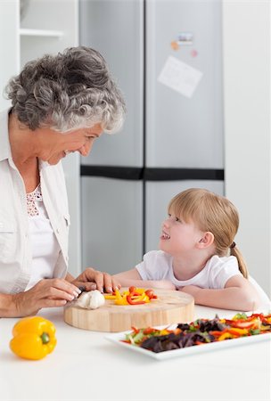 simsearch:400-04813285,k - Little girl looking at her grandmother who is cooking at home Stock Photo - Budget Royalty-Free & Subscription, Code: 400-04311183
