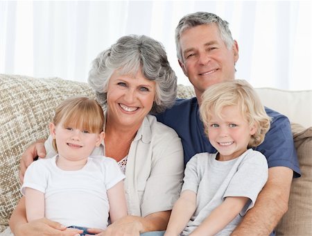 Joyful family looking at the camera at home Photographie de stock - Aubaine LD & Abonnement, Code: 400-04311196