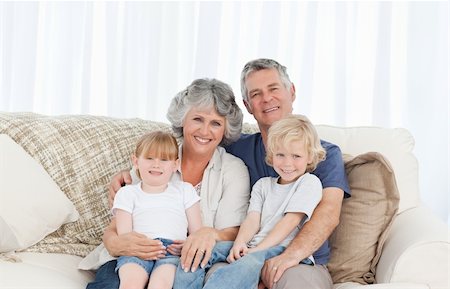 Joyful family looking at the camera at home Photographie de stock - Aubaine LD & Abonnement, Code: 400-04311199