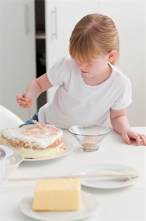 rolling over - Adorable girl baking in her kitchen at home Stock Photo - Budget Royalty-Free & Subscription, Code: 400-04311192
