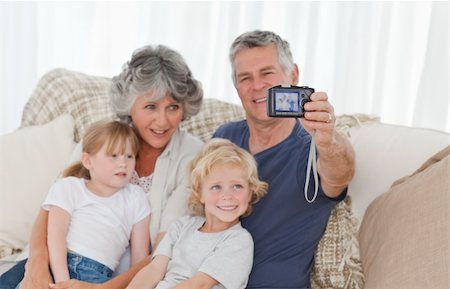 Family taking a photo of themselves at home Stock Photo - Budget Royalty-Free & Subscription, Code: 400-04311218