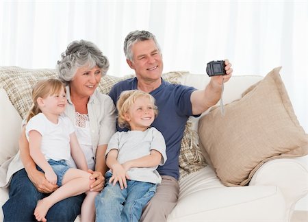 Family taking a photo of themselves at home Stock Photo - Budget Royalty-Free & Subscription, Code: 400-04311219