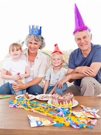 simsearch:400-04311221,k - Happy family looking at the camera on a birthday Photographie de stock - Aubaine LD & Abonnement, Code: 400-04311227