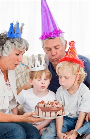 surprised grandmother - Children blowing on the birthday cake at home Stock Photo - Budget Royalty-Free & Subscription, Code: 400-04311222
