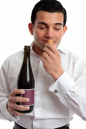 simsearch:400-04313696,k - A man sniffing the cork of a bottle of wine.  White background. Photographie de stock - Aubaine LD & Abonnement, Code: 400-04312050