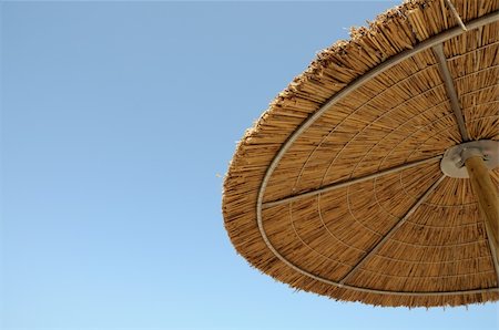 straw huts - Straw beach parasol umbrella and blue sky background. Stock Photo - Budget Royalty-Free & Subscription, Code: 400-04312265