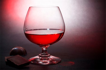 Luxury red liqueur on crystal balloon  glass and milk chocolate Stock Photo - Budget Royalty-Free & Subscription, Code: 400-04312387