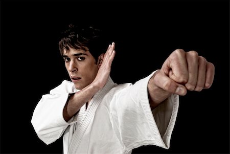 simsearch:400-04369150,k - Karate male fighter young close-up high contrast on black background. Foto de stock - Super Valor sin royalties y Suscripción, Código: 400-04312440