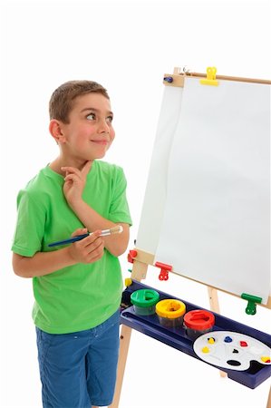 school boy in shorts - A young boy child stands by his easel and contemplates what do paint.  White background. Stock Photo - Budget Royalty-Free & Subscription, Code: 400-04312702