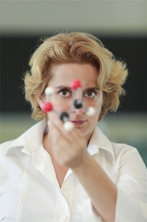 scientist and teacher photo - Female researcher analyzing a molecular model in a laboratory. Stock Photo - Budget Royalty-Free & Subscription, Code: 400-04312949