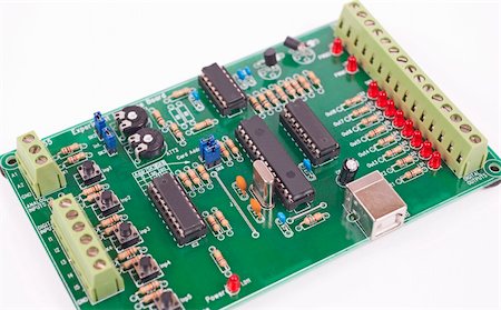 Closeup detail of an electronics circuit board isolated on white Stockbilder - Microstock & Abonnement, Bildnummer: 400-04313209