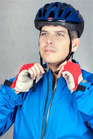 A close-up shot of a cyclist putting on his helmet. Stock Photo - Budget Royalty-Free & Subscription, Code: 400-04313512
