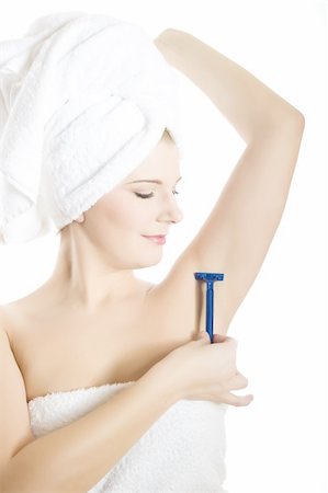 simsearch:400-04594366,k - close-up portrait of Young beautiful woman with healthy pure skin and wet hair in a towel holding a razor blade preparing to shave an armpit. isolated on white background. copy-space Photographie de stock - Aubaine LD & Abonnement, Code: 400-04313991