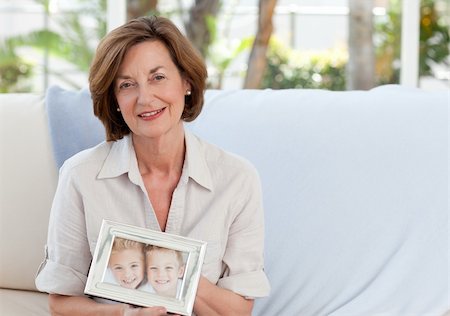 Mature woman showing her picture of her grandchild Stock Photo - Budget Royalty-Free & Subscription, Code: 400-04324332