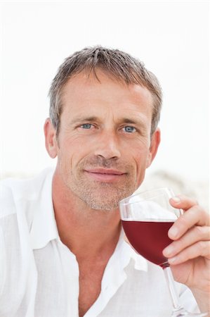 drunk at the sofa - Handsome man drinking some red wine at home Stock Photo - Budget Royalty-Free & Subscription, Code: 400-04324596