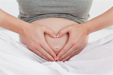 Pregnant woman doing heart sign on her belly Stock Photo - Budget Royalty-Free & Subscription, Code: 400-04324729