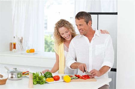 Couple cooking together in their kitchen at home Stock Photo - Budget Royalty-Free & Subscription, Code: 400-04324777