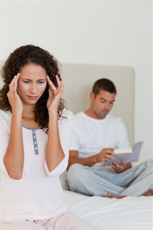 simsearch:649-03487806,k - Woman having a headache while her husband is reading Stock Photo - Budget Royalty-Free & Subscription, Code: 400-04324837