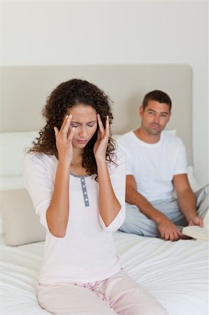 simsearch:649-03487806,k - Woman having a headache while her husband is reading Stock Photo - Budget Royalty-Free & Subscription, Code: 400-04324839